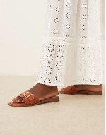 Nikola buckle flat sandals in tan